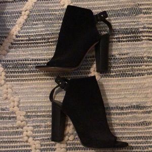 Suede Vince booties with a chic peep-toe profile.